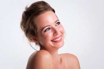 Beautiful young woman headshot with toothy smile at isolated white background with copy space