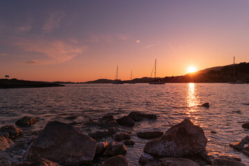 Sunset between boats and yachts on Illetes beach in Majorca, Balearic Islands, Spain