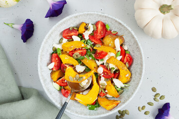 Pumpkin salad with cheese, pumpkin seeds and mini tomatoes