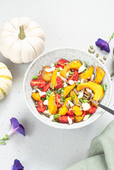 Pumpkin salad with cheese, pumpkin seeds and mini tomatoes