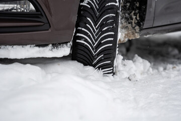 car tires on winter road covered with snow, close-up
