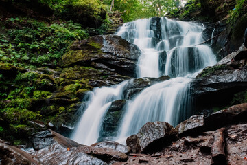 Fototapeta na wymiar waterfall in the forest in ukraine