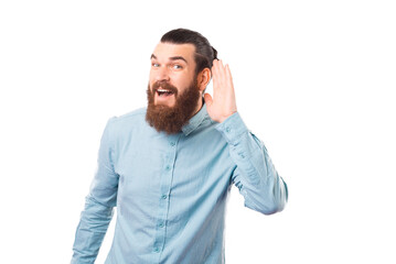 Fototapeta premium Surprised bearded man is making the hear gesture over white background.