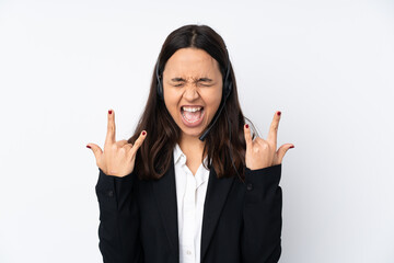 Young telemarketer woman isolated on white background making rock gesture