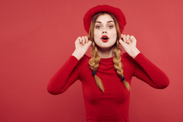 pretty woman in a red sweater cosmetics emotion red background