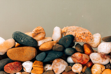 Colorful sea pebbles close-up. Background texture, sea stones in the water