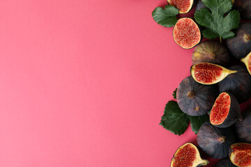 Fig with leaves on pink background, space for text