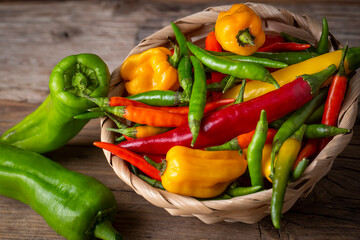Colorful hot peppers on wooden background