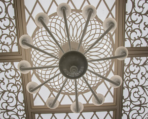 carved ceiling with lighting in light colors