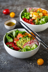 Two plates with poke, tomatoes and olive oil