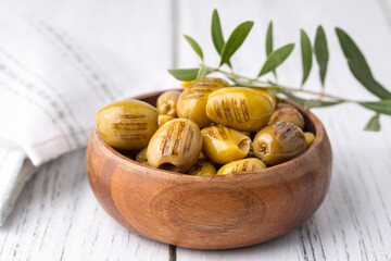 Grilled green olives. Tasty organic green olives in the plate.