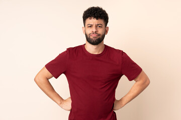 Fototapeta premium Young Moroccan man isolated on beige background angry