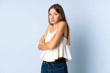 Young Lithuanian woman isolated on blue background making doubts gesture while lifting the shoulders