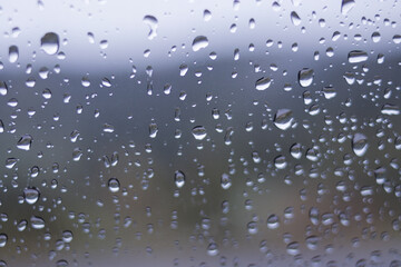 Defocused abstract background of raindrops on windshield car after rain