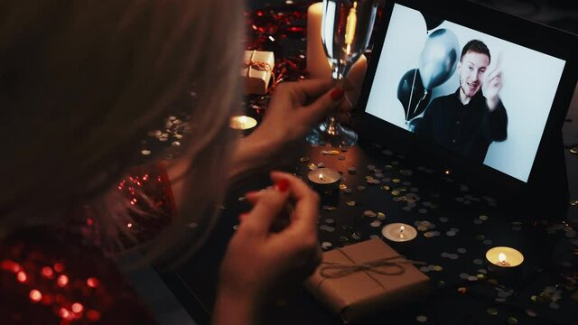 Romantic video call. Online Valentine day. Holiday Internet date. Virtual celebration. Distance relationship. Happy couple drinking champagne greeting using tablet at festive night.