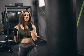 Fototapeta na wymiar Girl at gym boxing