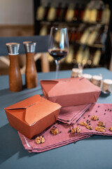 Naklejka na ściany i meble closeup of kraft paper food containers with meal on cafe table for delivery