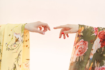Colorful linen satin or silk cloth fabrics in yellow and green colors. Hands one by one similar to...