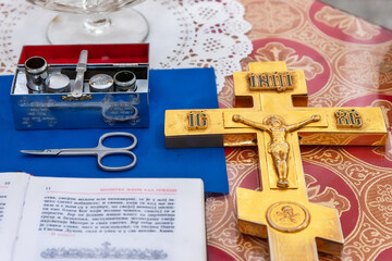 Belgrade, Serbia July 24, 2021: Orthodox Church of St. Luke the Apostle (Crkva Svetog Luke: serbian). Accessories of a priest for Christian baptism. The text in the book is in Serbian