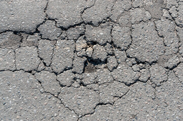 The asphalt cracked on the road