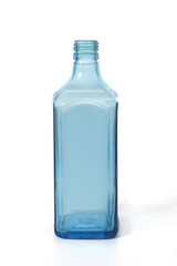 blue glass bottle of dry gin standing on white background