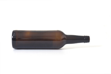 brown glass alcohol bottle lying on white background