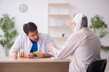 Old male patient visiting young male doctor dentist