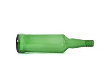 green glass bottle of whisky lying on white background