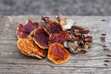 Boletus on the old wooden table. Dried mushrooms for delicious dishes. Healthy and vegetarian food.