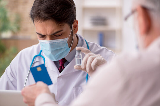 Old male patient visiting young male doctor in vaccination conce