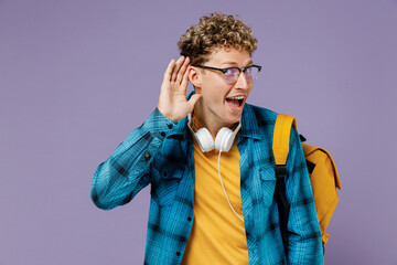 Young boy teen student in casual clothes backpack headphones glasses try to hear you listen...
