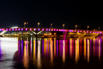 Fototapeta na wymiar Novi Sad, Serbia August 24, 2021: Rainbow bridge, Novi Sad, Serbia. Night reflection in Novi Sad