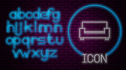 Glowing neon line Sofa icon isolated on brick wall background. Neon light alphabet. Vector