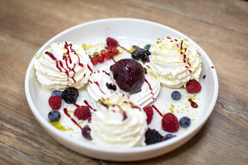 Pavlova with fruits of the day, meringue and chantilly