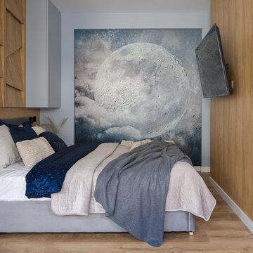 Small bedroom with wooden wall and moon poster