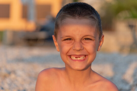 Young toothless boy at the beach
