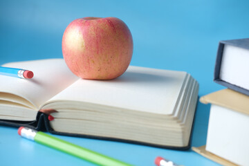 black to school concept with apple on notepad on table.