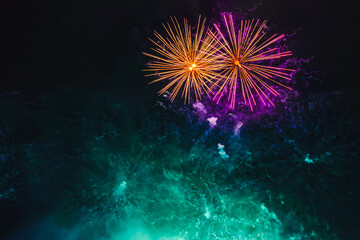 Holiday Fireworks with colorful sparks, bright smoke and bright nebula on black sky