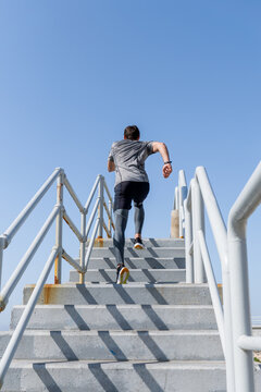 Man running up stairs outside