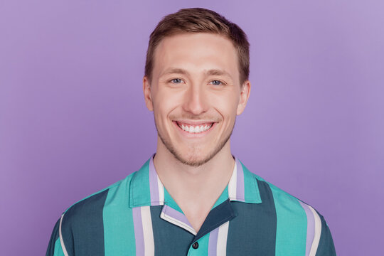 Portrait of positive cherful nice attractive guy toothy beaming smile on violet background