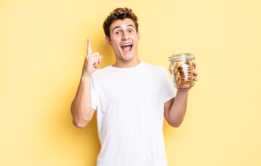 feeling like a happy and excited genius after realizing an idea, cheerfully raising finger,...