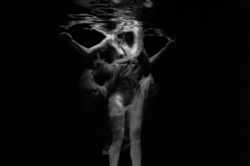 Black and white photographs where a beautiful girl poses in the water. She looks like a mythical...