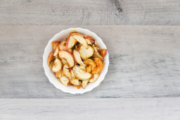 dried apples dried fruits on a plate on wooden background
