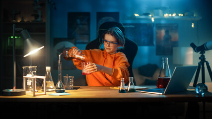Smart Young Boy in Safety Glasses Mixes Chemicals in Beakers at Home. Teenager Conducting Educational Science Hobby Experiments, Doing Interesting Biology Homework in His Room.