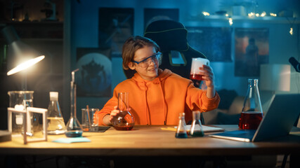 Fototapeta na wymiar Smart Young Boy in Safety Glasses Mixes Chemicals in Beakers at Home. Teenager Conducting Educational Science Hobby Experiments, Doing Interesting Biology Homework in His Room.