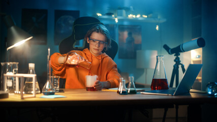 Smart Young Boy in Safety Goggles Mixes Colorful Chemicals in Beakers at Home. Teenager Conducting Educational Science Hobby Experiments, Doing Interesting Biology Homework in His Room.