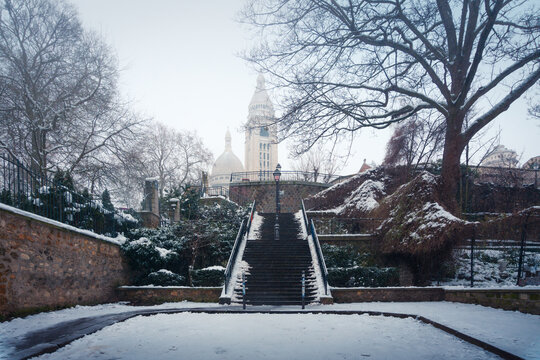 Stairway leading to Sacre Coeur Basilica in misty winter park