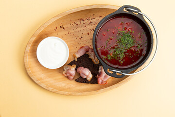 Traditional soup borsch. In a plate on a light background.
