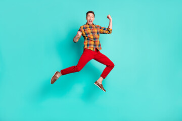 Fototapeta na wymiar Full body photo of funky brunet millennial guy jump wear shirt turquoise sneakers isolated on teal background
