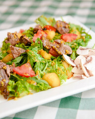 Salad with beef, tomatoes, fresh lettuce salad and arugula, raw mushrooms and great dressing from dijon mustard.